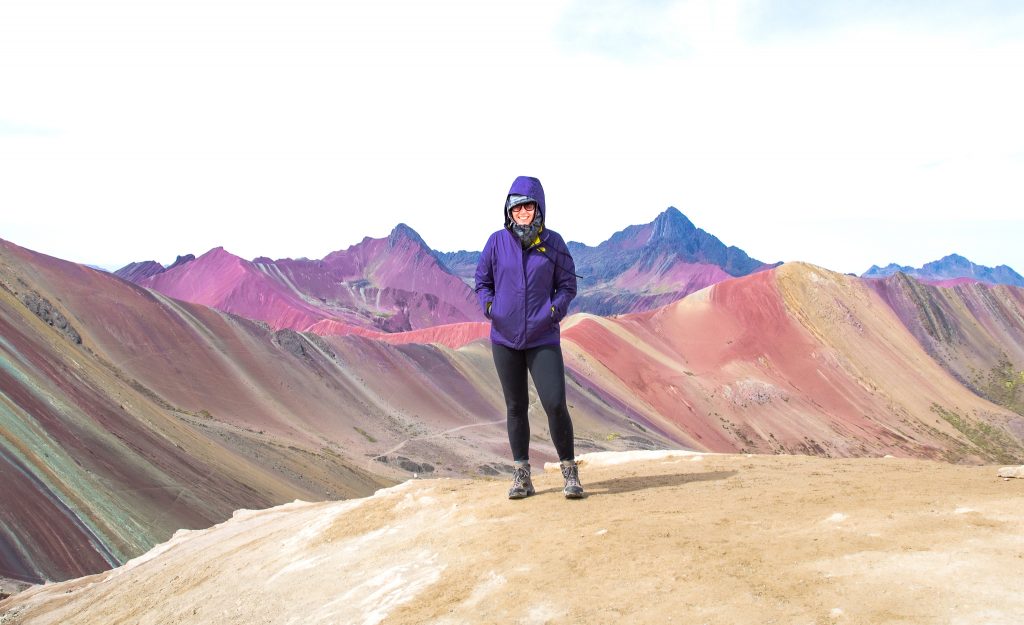 The rainbow mountains in Peru is one of the most beautiful places I've visited. The rainbow mountains photography I captured on our 1 day trek will inspire, and make it worth visiting the mountains. My itinerary provides what to wear, outfits, food, how to get there and more. | Her Life Adventures | #rainbow #mountains #peru #photography #outfit #beautiful #places #trek #travel #destinations #food #itinerary