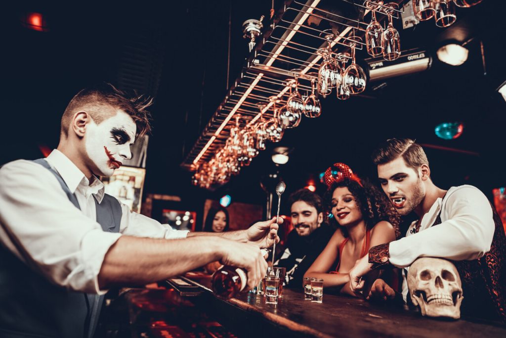 Bartender in Halloween Costume Making Cocktail.