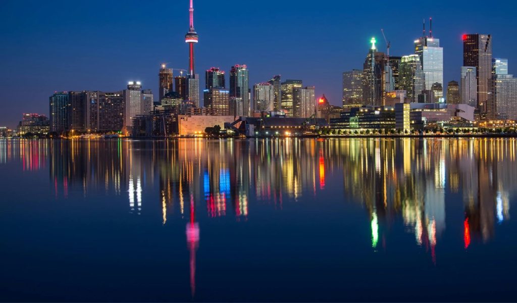 Buildings Near Body Of Water At Night
