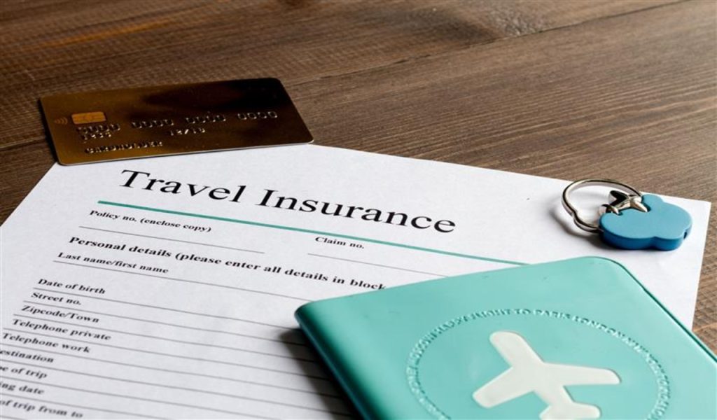 concept booking travel insurance on wooden background