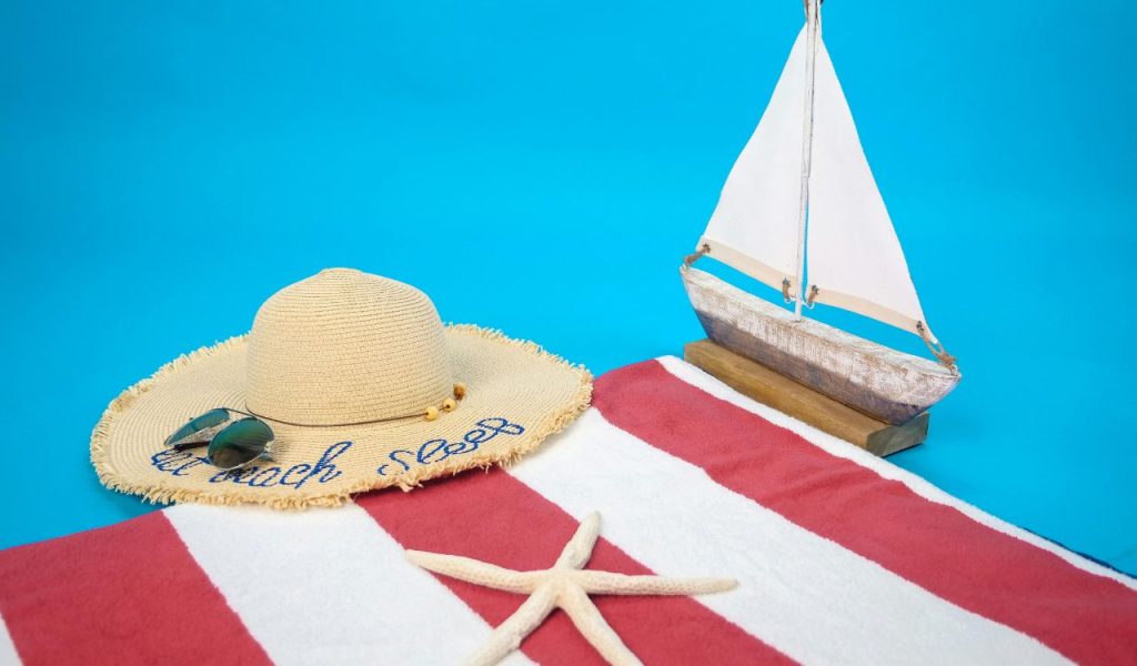 Brown and White Sail Boat on White and Red Textile