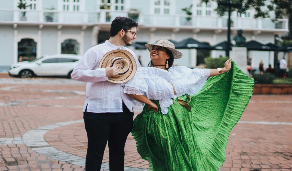 Man and Woman in Traditional Clothing Dancing on the Street