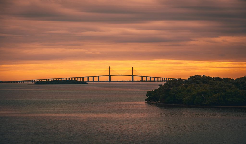 Suspension Bridge over a River at Sunset