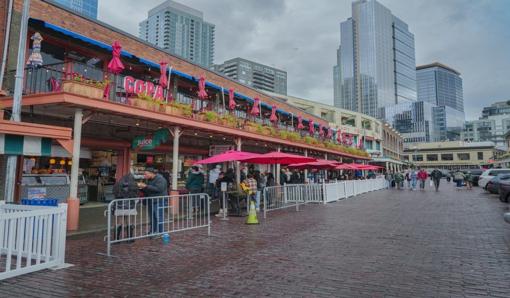 Lively Urban Market Scene with Red Umbrellas
