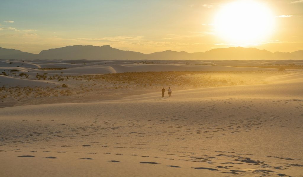 10 Spots Where Travelers Keep Reporting UFO Sightings – Her Life Adventures People on Desert at Sunset