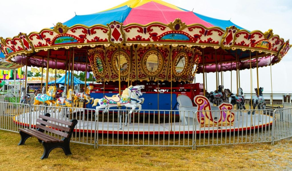 8 State Fairs with Big October Weekends – Her Life Adventures Colorful Carousel at a Country Fair in Pennsylvania