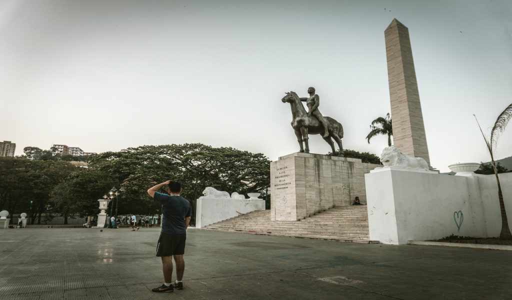 A Man Standing Near the Statue
