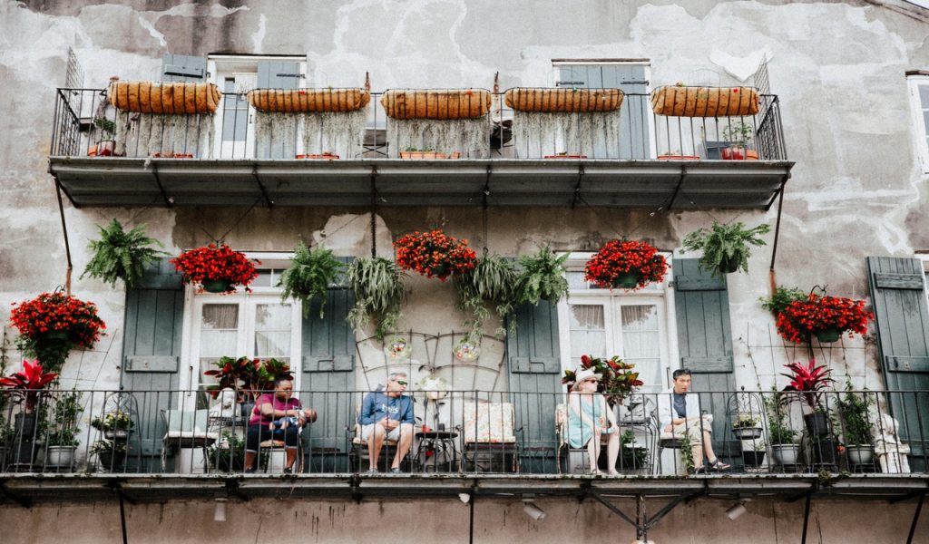 People Sitting on the Balcony of a Building in the French Quarter in New Orleans, Louisiana 