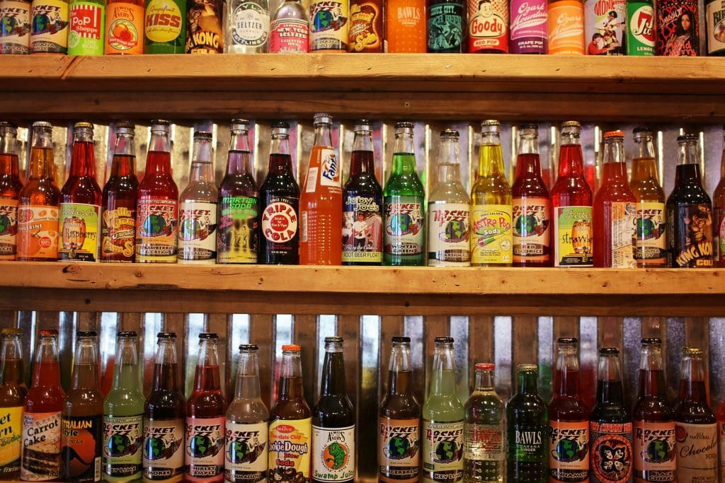 Colorful bottles of soda pop on store shelf