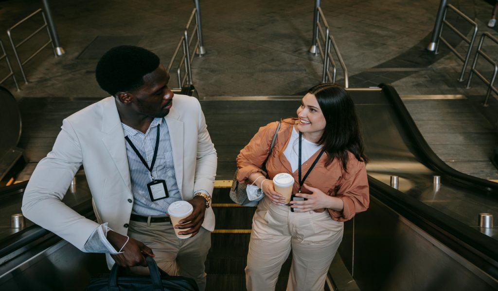 Femme souriante et homme sur l'escalator