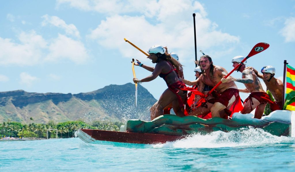 People Riding a Boat While Holding Paddles 
