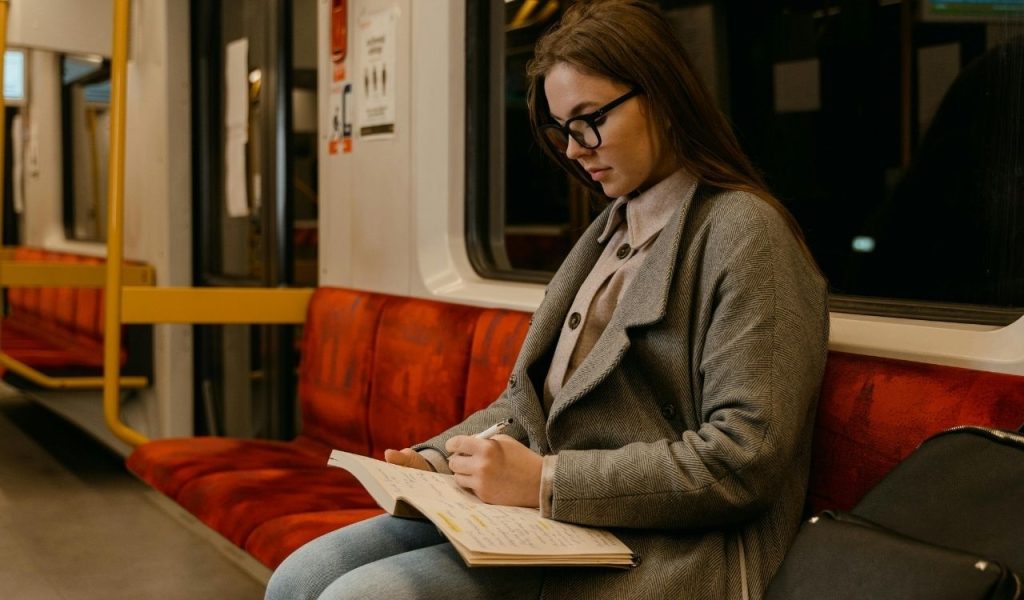 Woman Studying while in the Train