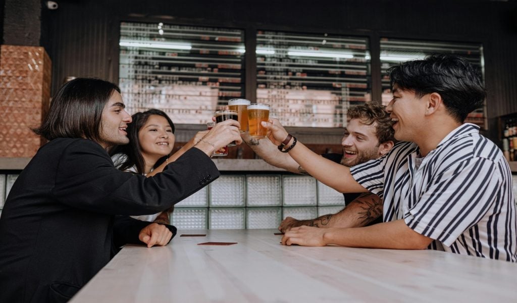 11 U.S. Cities Beer Lovers Should Put on the Map – Her Life Adventures Photo of a People Doing a Toast at the Bar