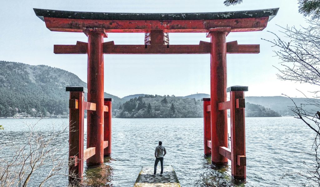 Man in Gray Jacket Standing on Dock