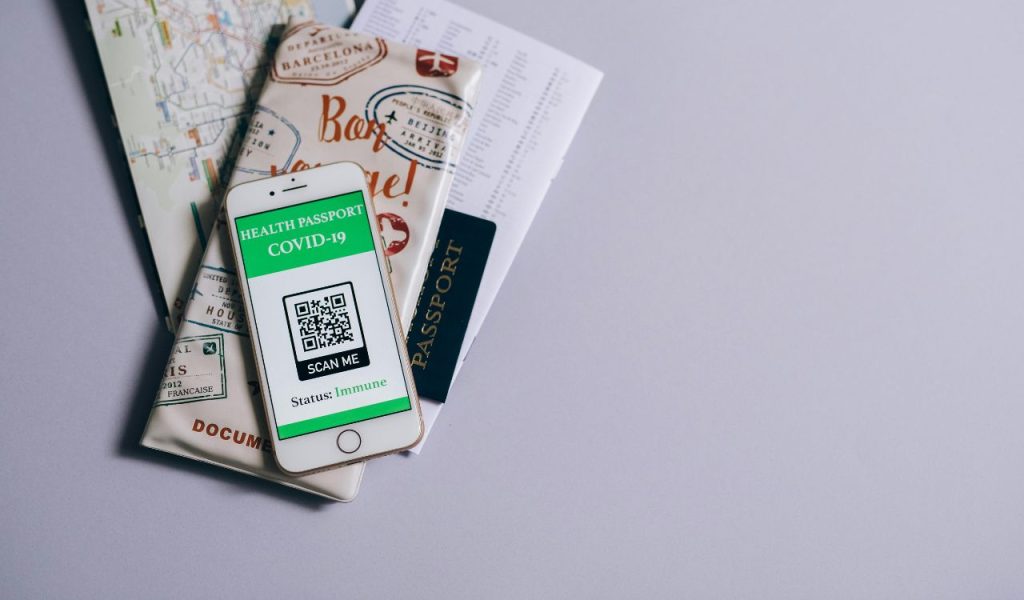 Phone with Health Passport on Maps on Table