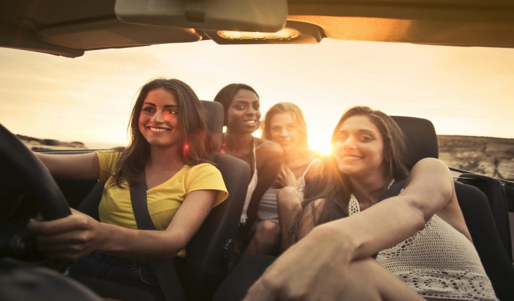 Photo Of Women Sitting On Car
