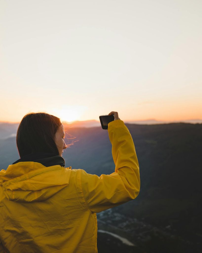 A traveler taking photos early morning at a major landmark