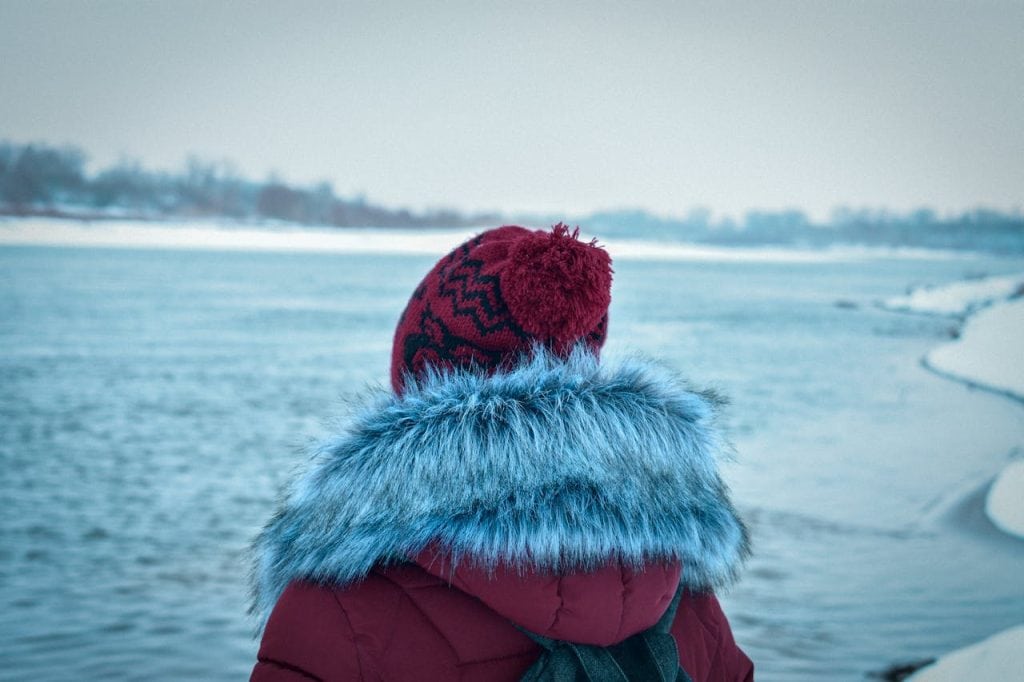 8 Travel Gear Items To Leave At Home For October Trips – Her Life Adventures A Woman Wearing Heavy Winter Coats