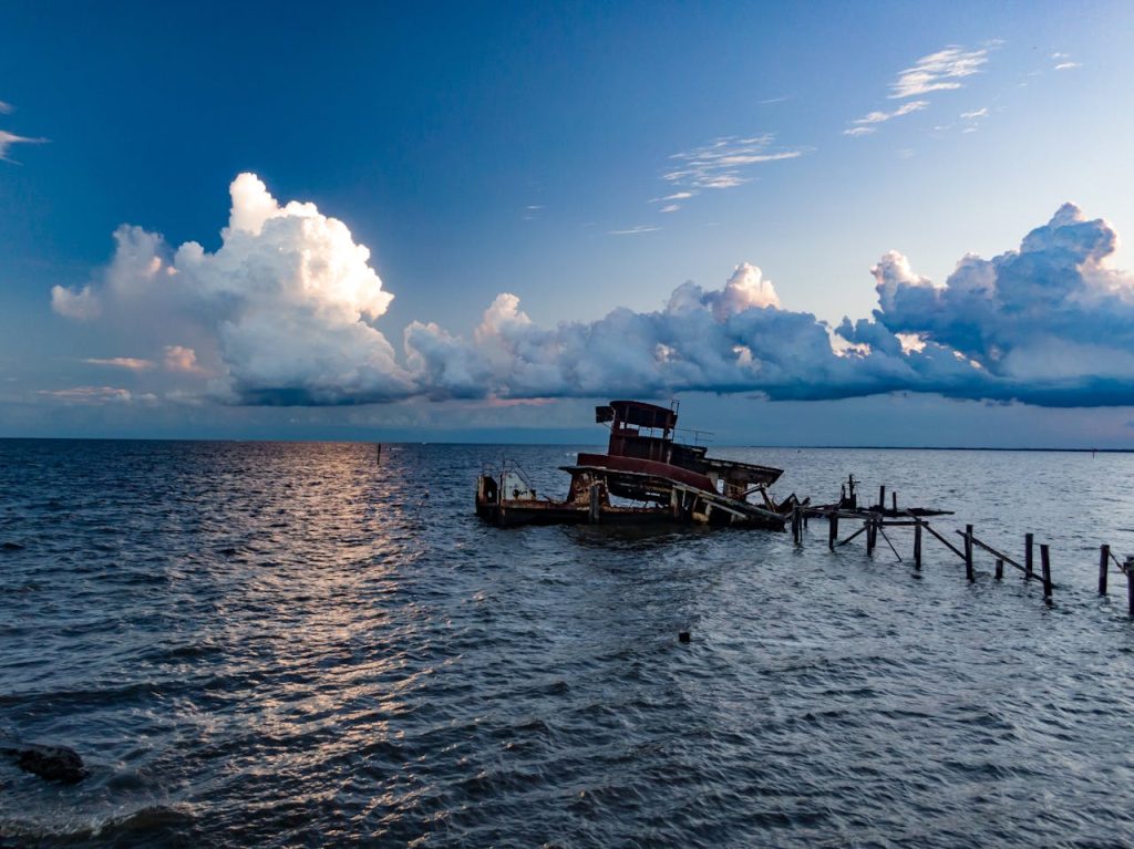 Tugboat Wreckage on Lake Pontchartrain with White Clouds on Background