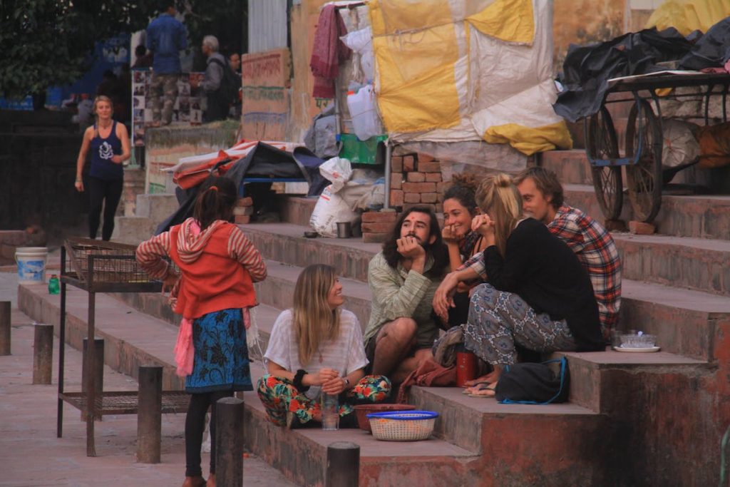 Group of Friends Relaxing on Steps in a Market