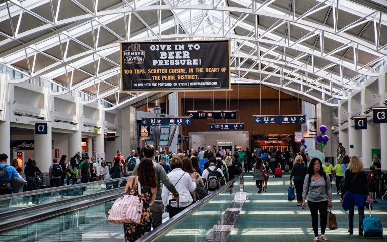 ass of People Walking and Using Walkalator Inside a Building