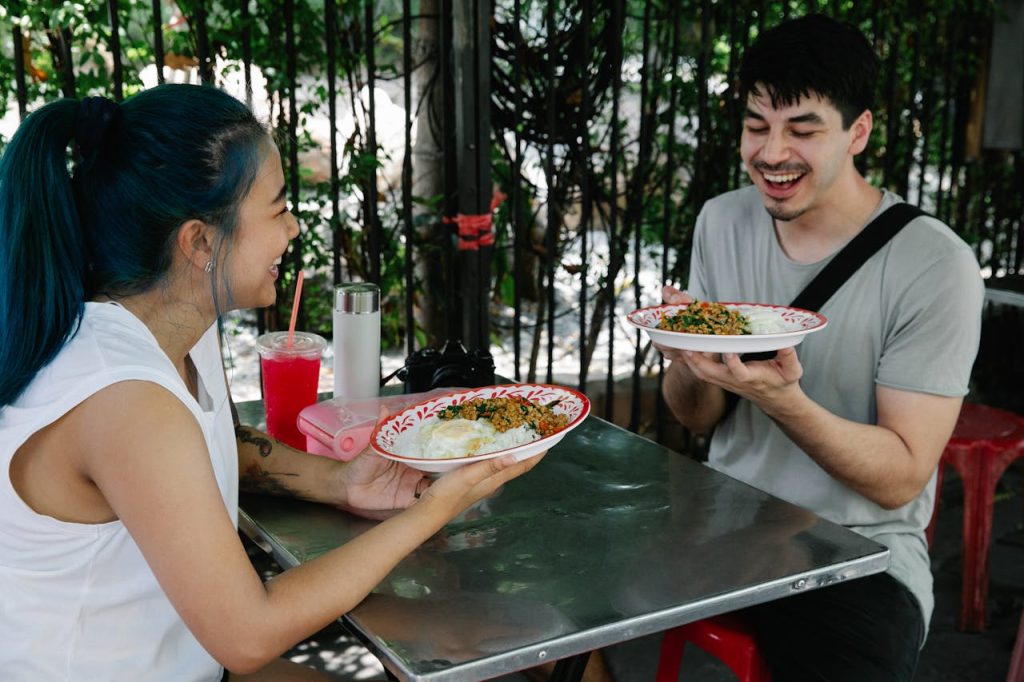 A traveler trying new dishes at a local restaurant or food stall.