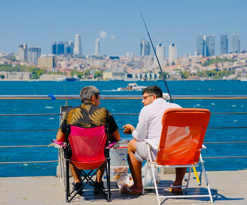 8 Travel Gear Items To Leave At Home For October Trips – Her Life Adventures Two Person Sitting on a Chair and Fishing