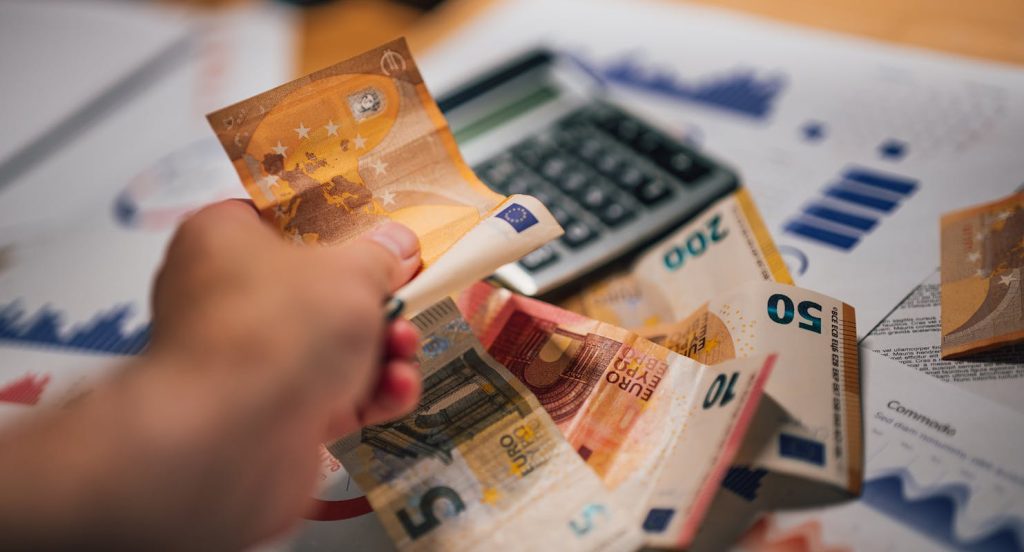 Euro Banknotes with Financial Documents