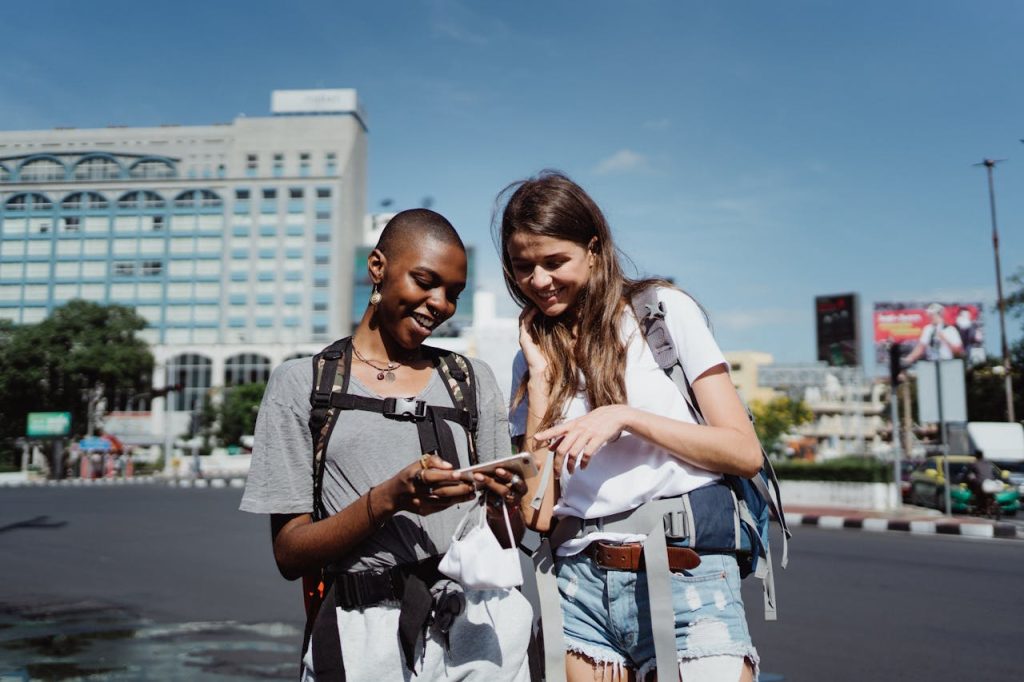 A traveler checking navigation on a phone in a city street or metro.