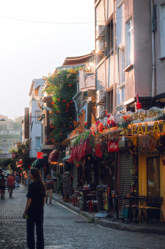 A traveler exploring a colorful local neighborhood or open market off the main path.