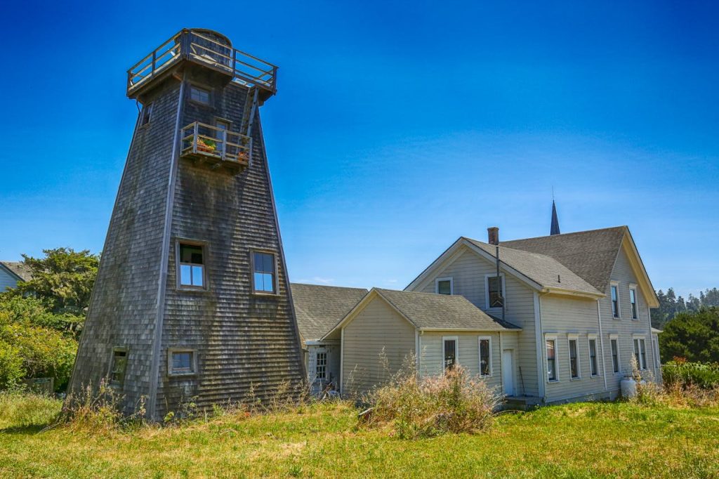 Vintage Water Tower near Houses in Village
