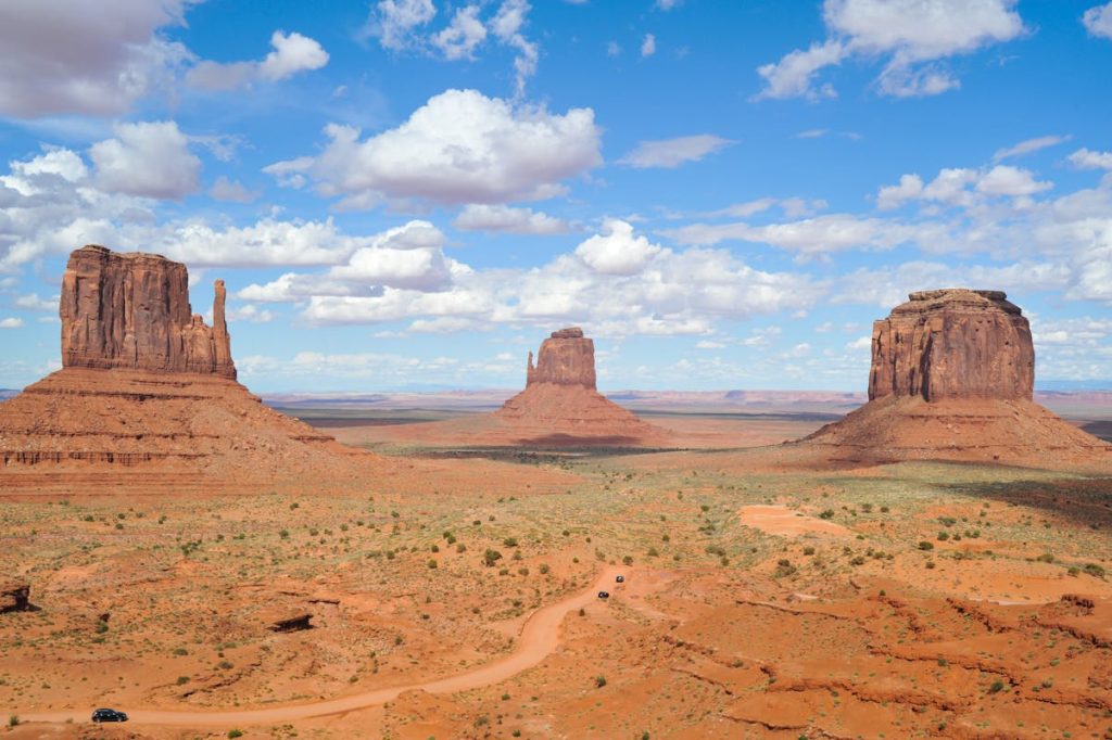 9 American Film Locations Where Travelers Can Relive Iconic Scenes – Her Life Adventures Brown Rock Formation Under White and Blue Cloudy Sky