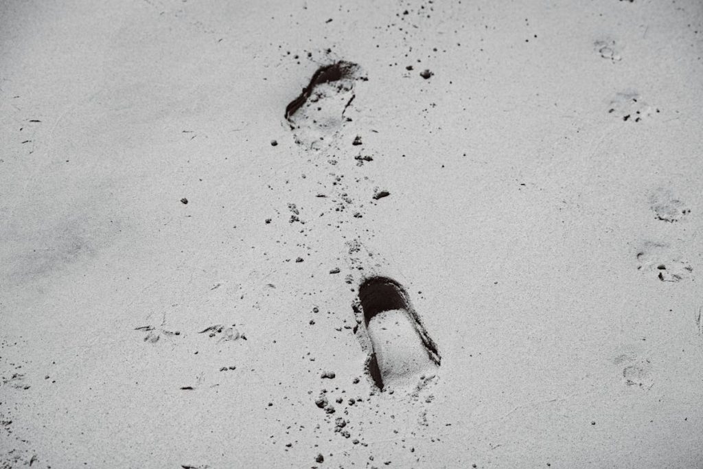 Footprints on Gray Sand
