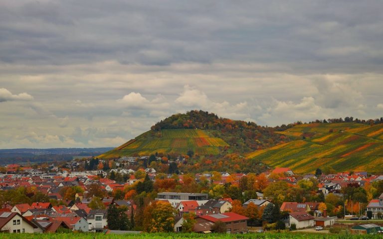 Colorful Autumn Landscape with Hills and Village