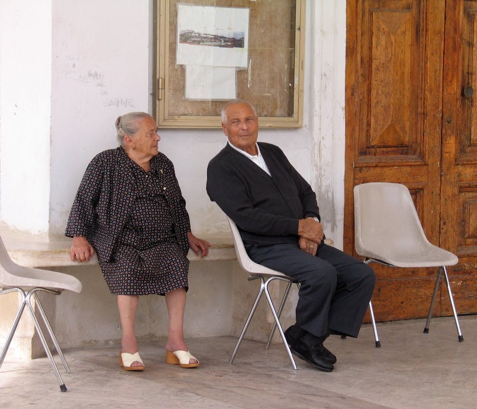 A couple sitting on chairs