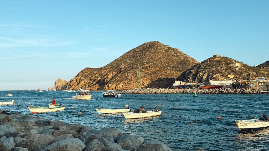 Scenic Coastal View with Fishing Boats at Sunset