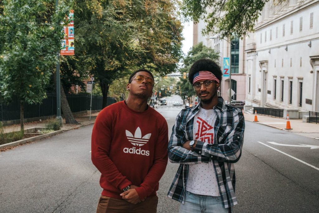 Two Men Standing on Paved Road