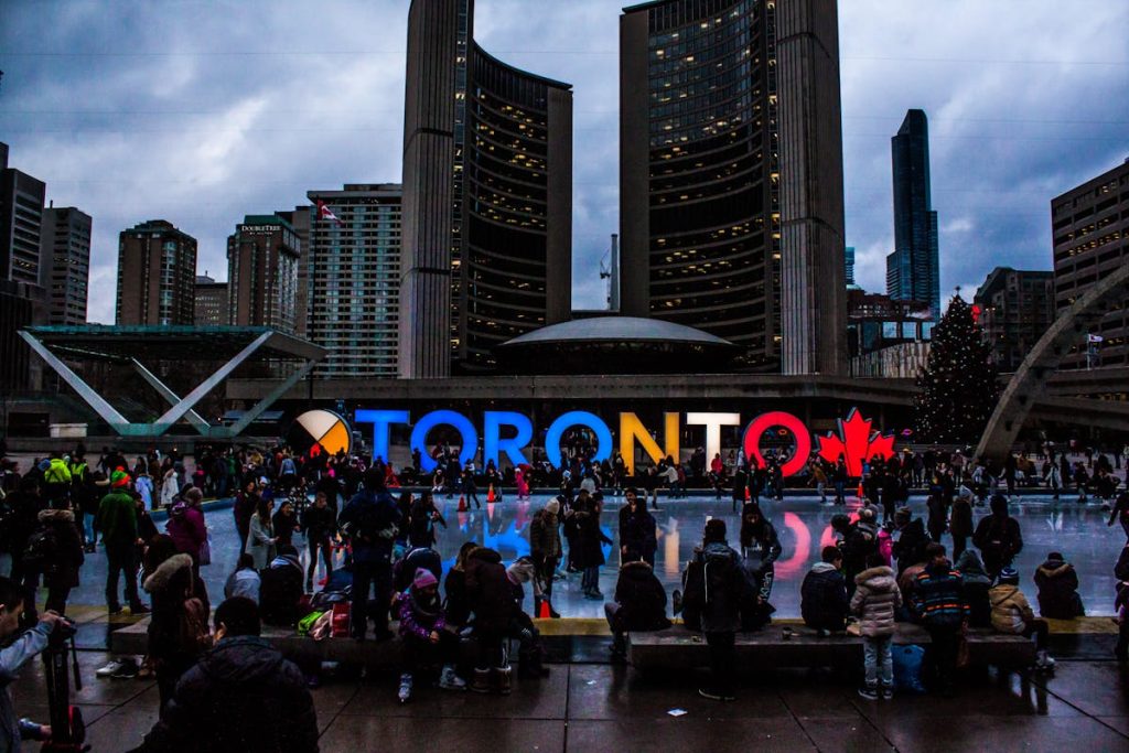 10 Countries With Rising Trip Costs And How To Budget For Them – Her Life Adventures People Gathered in Front of Toronto Freestanding Signage