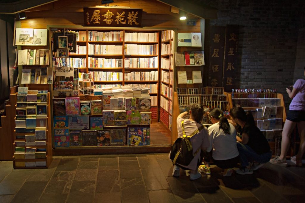 Charming Street Bookstore with Browsing Customers