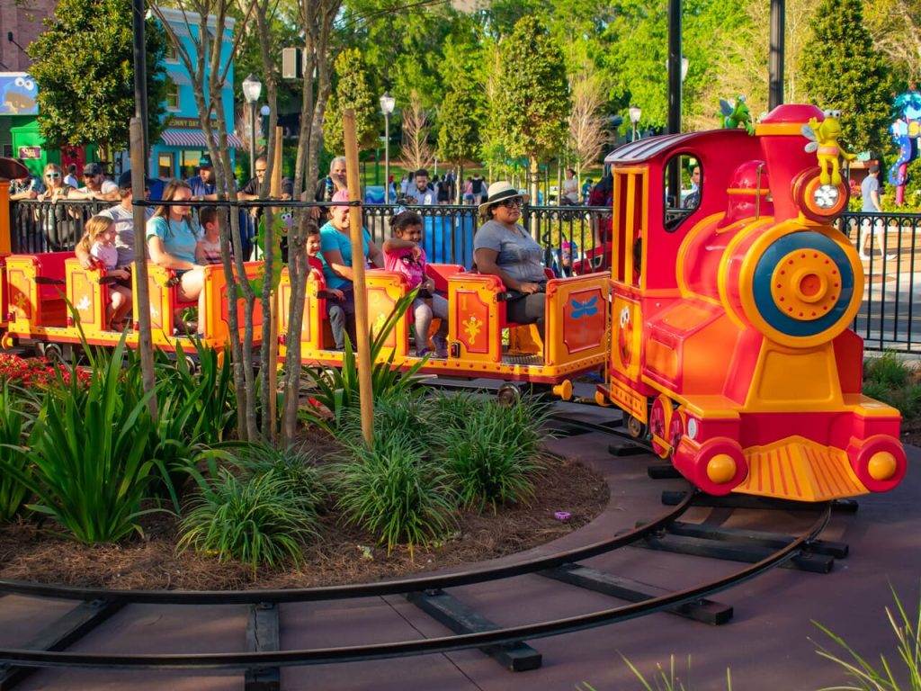 Small amusement park train winding through trees