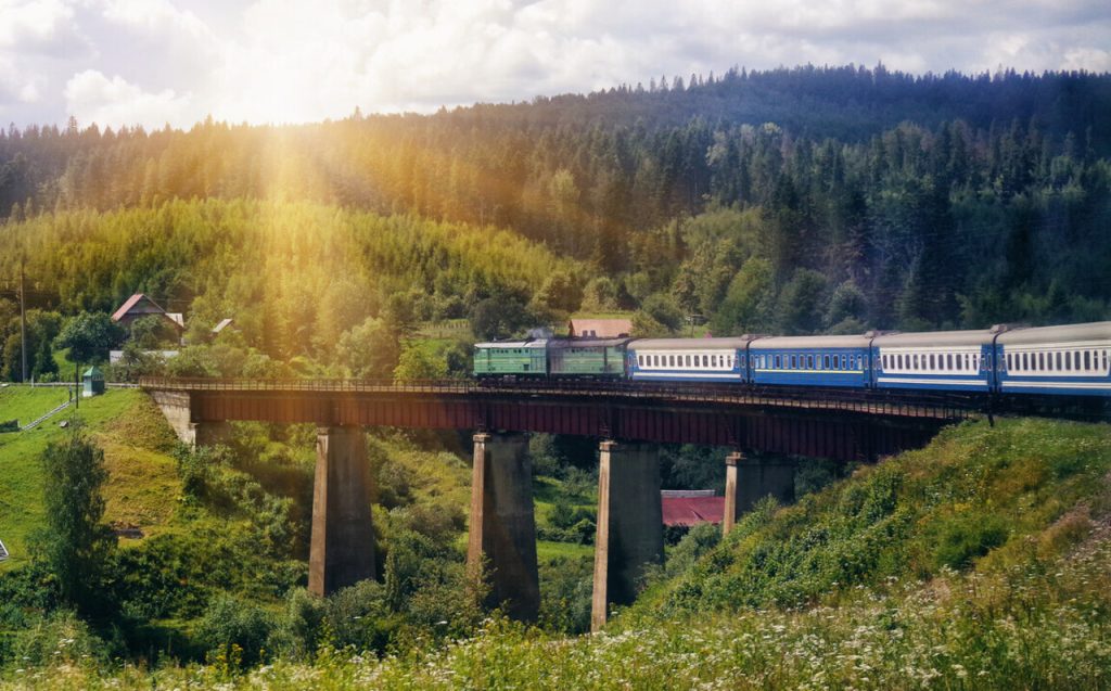 Train crossing a bridge in a mountainous area