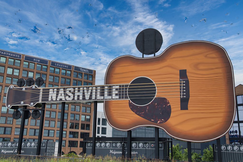 Guitar on the background of a modern building in the city