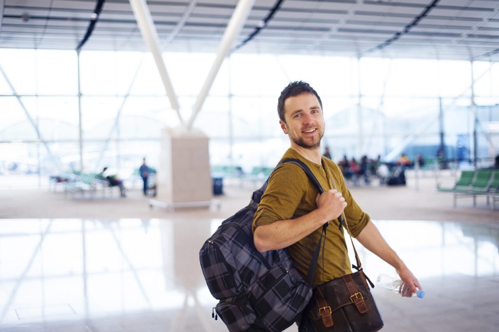 Young man is waiting at the airport for his flight