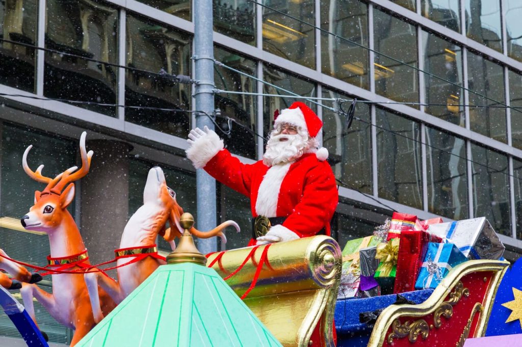 Santa waving from his sleigh during a parade