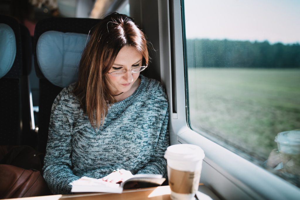 Women reading book on the train