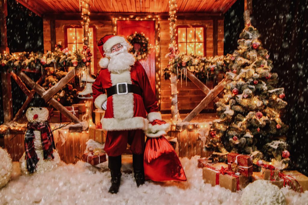 Santa welcoming visitors inside his rustic cabin