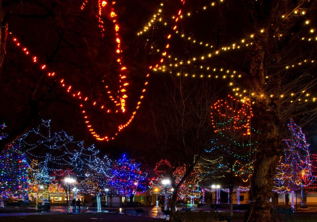 You step into Santa Fe’s Plaza and feel the lights, music, and warmth pull you into the holiday season the moment the night begins.