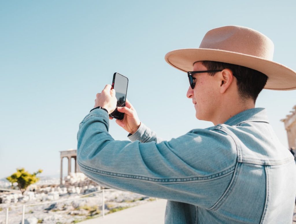 Man Wearing Denim Jacket Holding a Cellphone