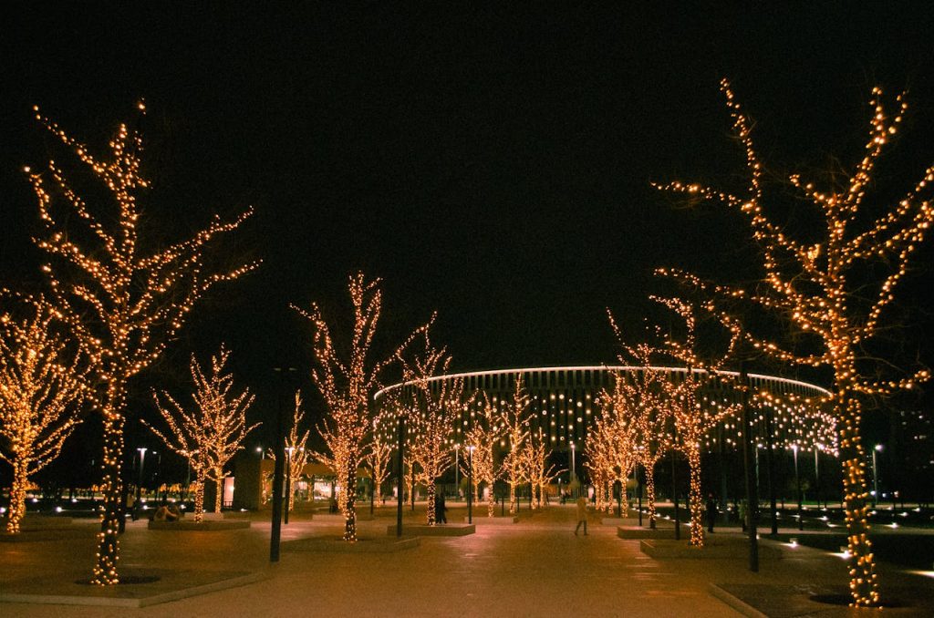 rows of luminarias glowing along adobe paths,