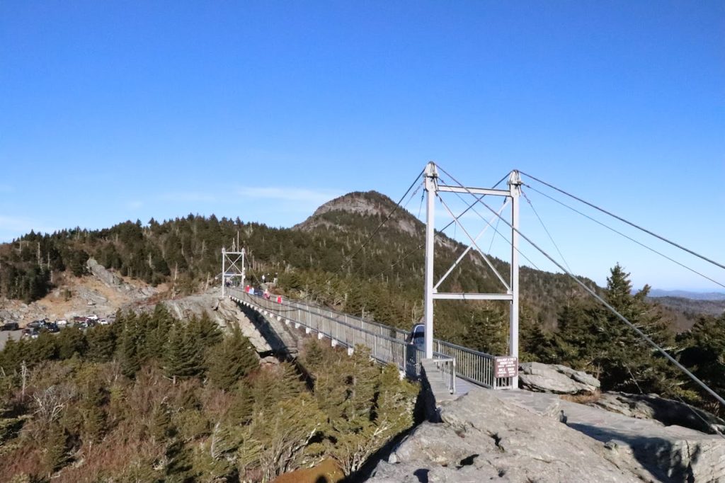 The suspension bridge is on top of a mountain
